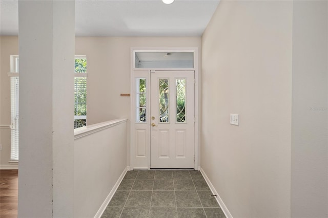 doorway with tile patterned floors