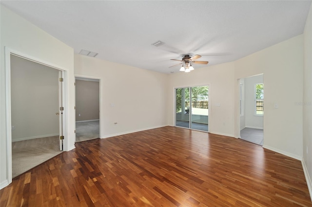 empty room featuring ceiling fan and carpet