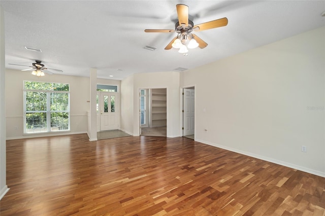 unfurnished living room with ceiling fan and hardwood / wood-style flooring