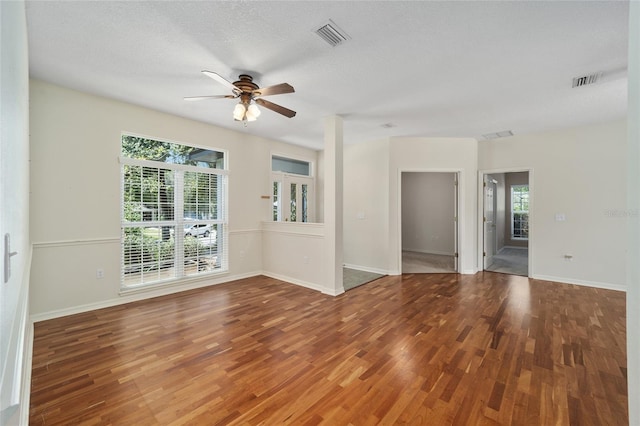 spare room featuring ceiling fan, wood-type flooring, and a textured ceiling