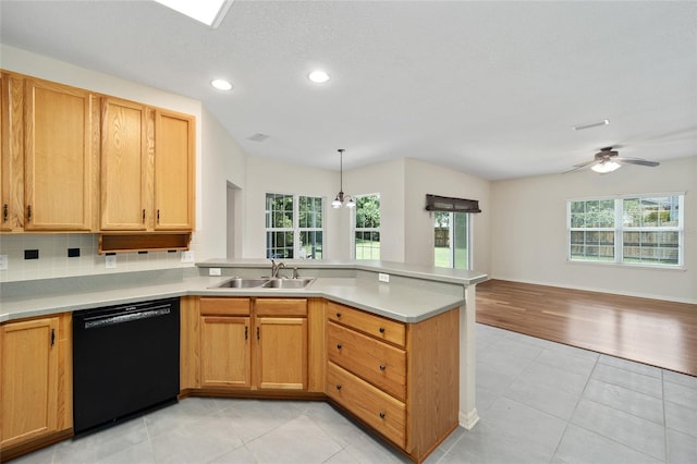 kitchen featuring sink, dishwasher, light tile patterned flooring, and plenty of natural light