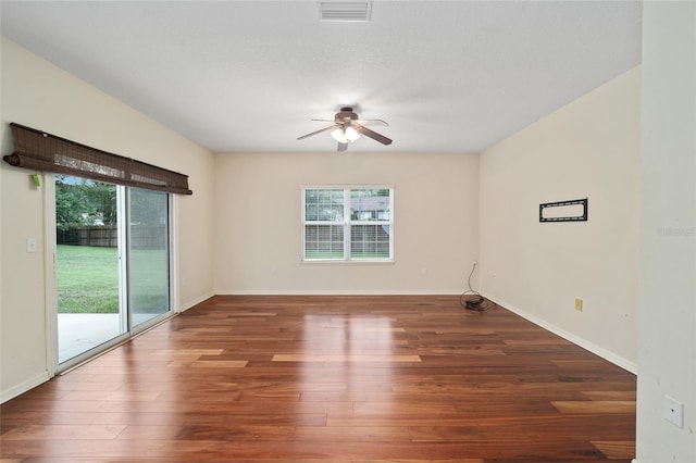 spare room with ceiling fan, a wealth of natural light, and hardwood / wood-style flooring