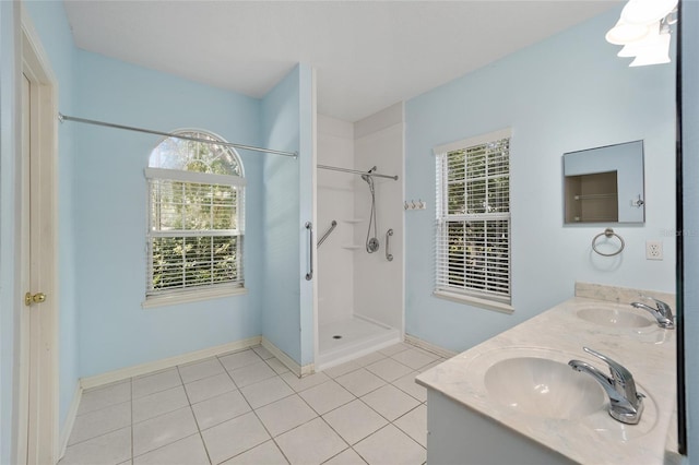 bathroom featuring dual vanity, walk in shower, and tile patterned flooring