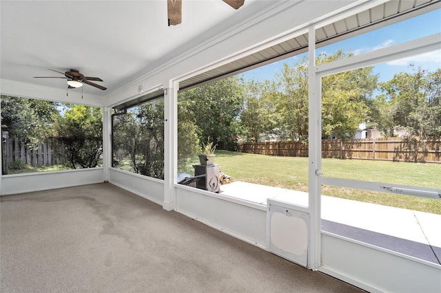 unfurnished sunroom with ceiling fan