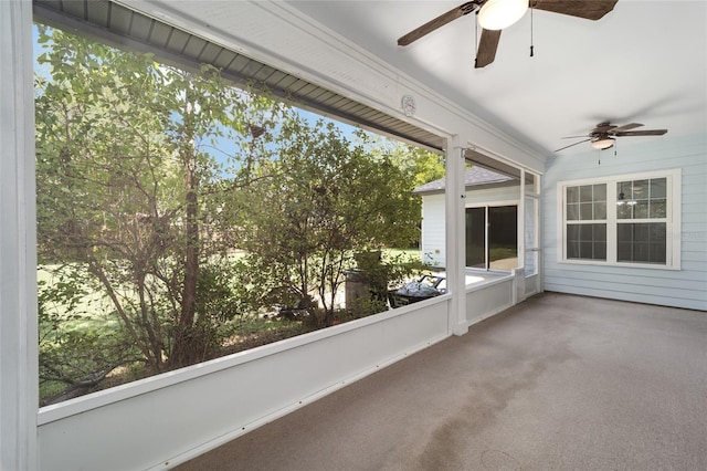 unfurnished sunroom featuring ceiling fan