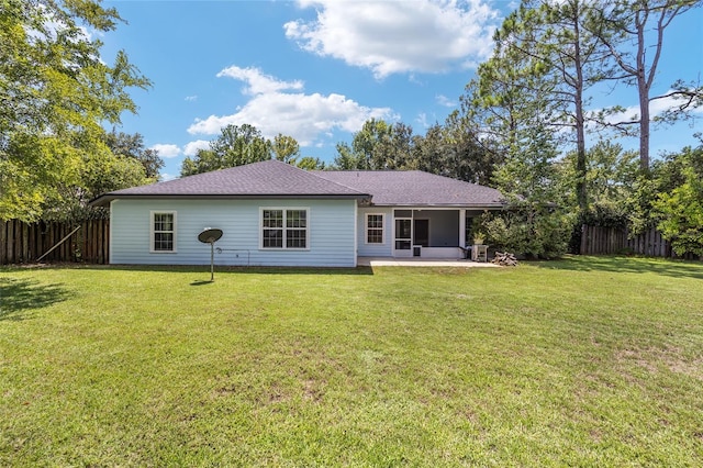 back of house with a patio and a yard