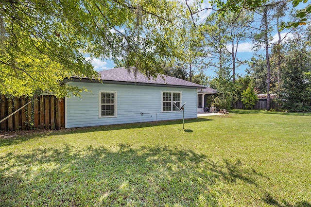 back of house with a lawn