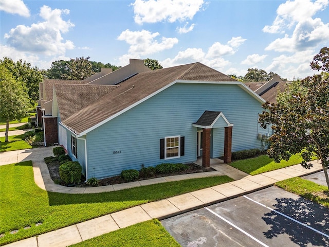 10545 NW 30th Ln, Gainesville, FL 32606 - view of front of property with roof with shingles, a front yard, and uncovered parking