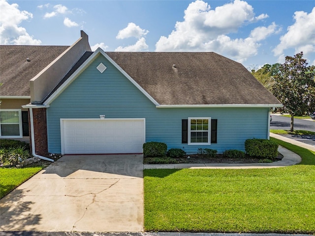 view of front of home featuring a garage and a front yard