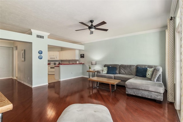 living room with ceiling fan, hardwood / wood-style flooring, and ornamental molding