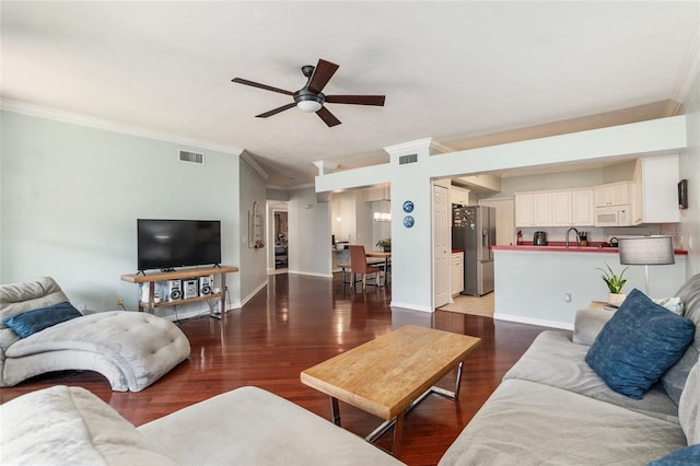 living room featuring ceiling fan, hardwood / wood-style floors, and ornamental molding