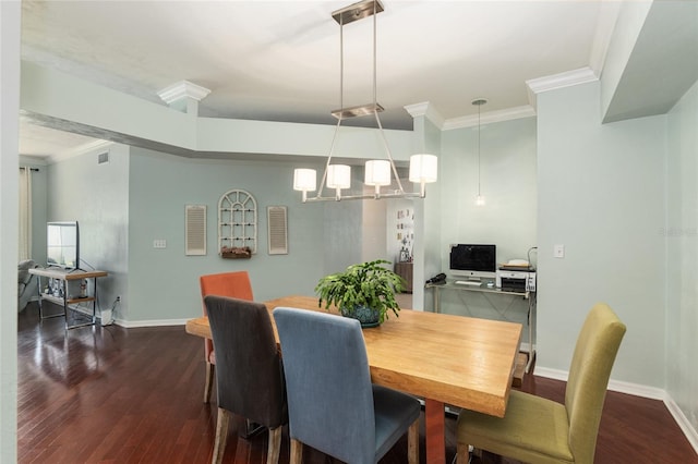 dining area with dark hardwood / wood-style flooring, an inviting chandelier, and crown molding