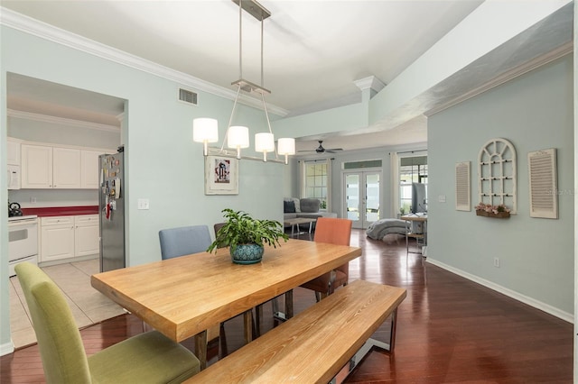 dining room featuring crown molding, ceiling fan with notable chandelier, french doors, and wood-type flooring