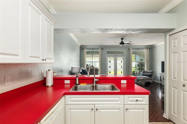 kitchen with sink, a textured ceiling, hardwood / wood-style flooring, and kitchen peninsula