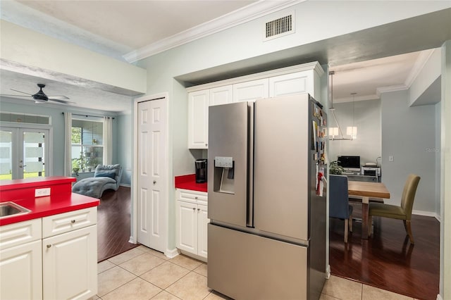 kitchen featuring ceiling fan, white cabinets, white fridge with ice dispenser, and light hardwood / wood-style flooring