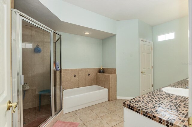 bathroom featuring tile patterned floors, shower with separate bathtub, and vanity