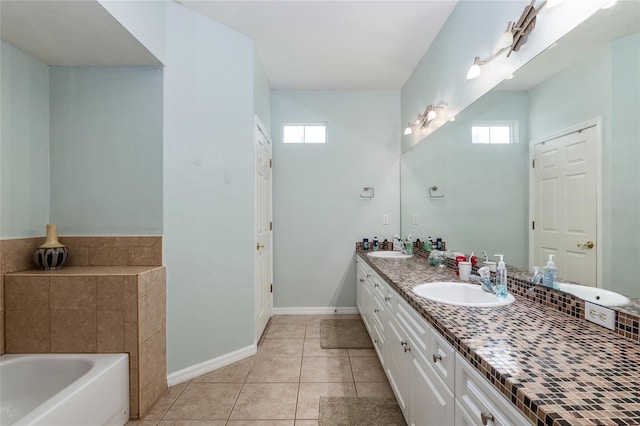 bathroom featuring a washtub, double sink vanity, plenty of natural light, and tile patterned flooring