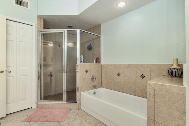 bathroom featuring tile patterned floors and shower with separate bathtub