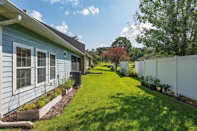 10545 NW 30th Ln, Gainesville, FL 32606 - view of yard featuring central air condition unit, fence, and a vegetable garden