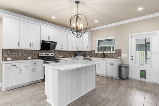 kitchen featuring pendant lighting, white cabinetry, stainless steel appliances, and a center island