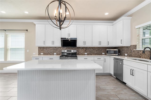 kitchen with white cabinetry, appliances with stainless steel finishes, sink, and pendant lighting