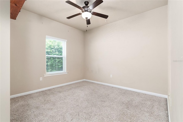 carpeted spare room with ceiling fan