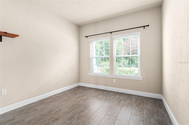 empty room with hardwood / wood-style flooring