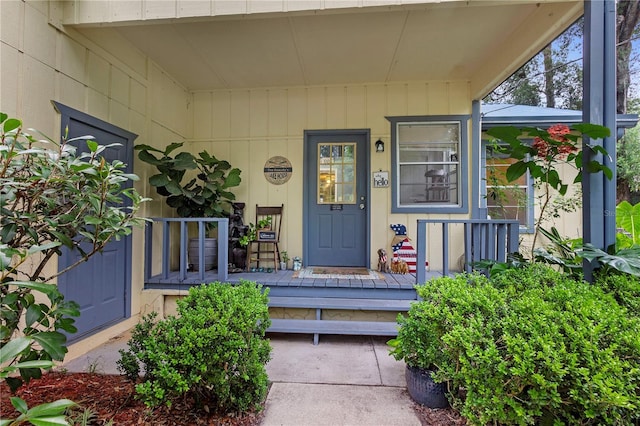 view of exterior entry with a porch