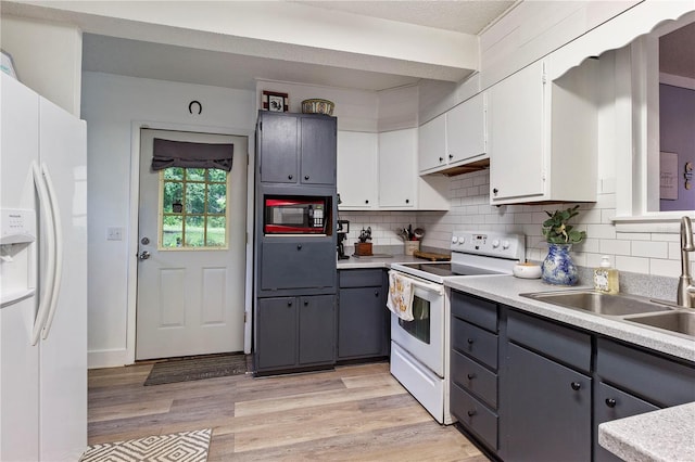 kitchen with white cabinets, light hardwood / wood-style flooring, white appliances, and gray cabinets