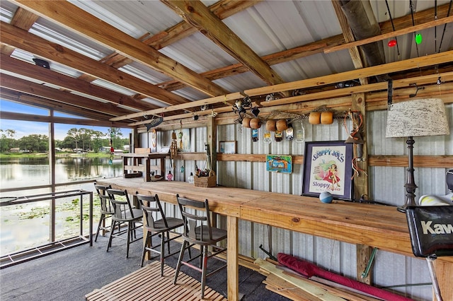 interior space featuring vaulted ceiling and a water view