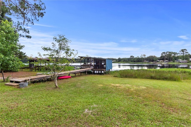 dock area featuring a water view and a lawn