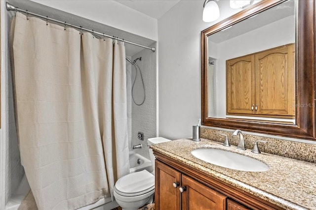 full bathroom featuring vanity, shower / bath combo with shower curtain, and toilet