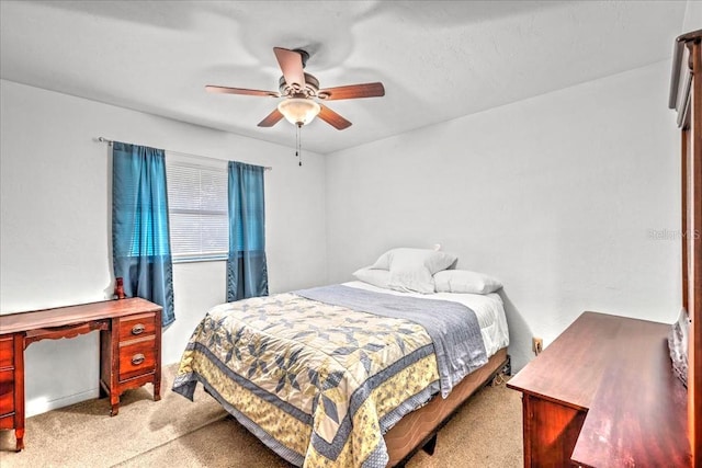 bedroom with ceiling fan and light colored carpet