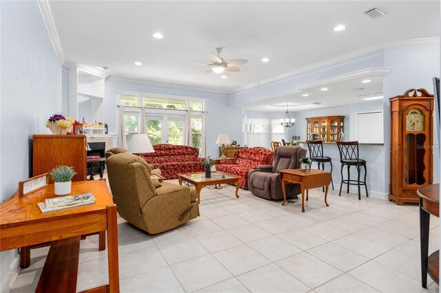 tiled living room featuring ceiling fan with notable chandelier and ornamental molding