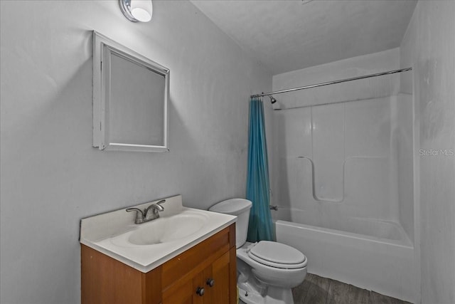 full bathroom featuring wood-type flooring, toilet, shower / bath combo with shower curtain, and vanity