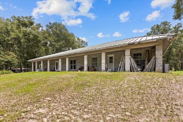 7340 NW 21st Ave, Bell, FL 32619 - back of house with central air condition unit, a standing seam roof, and metal roof