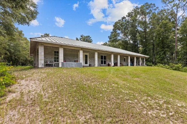 rear view of house with a yard