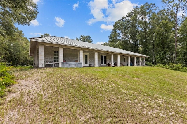 7340 NW 21st Ave, Bell, FL 32619 - rear view of property featuring a yard and metal roof