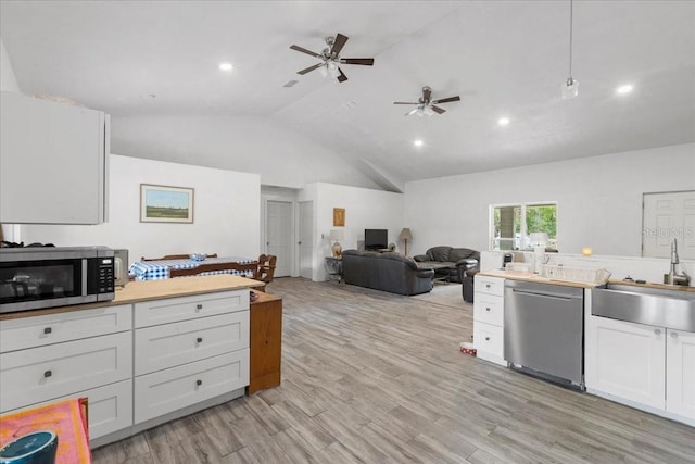 7340 NW 21st Ave, Bell, FL 32619 - kitchen with a sink, white cabinetry, a ceiling fan, appliances with stainless steel finishes, and vaulted ceiling