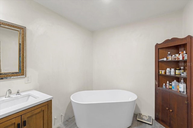 7340 NW 21st Ave, Bell, FL 32619 - full bath featuring vanity, a freestanding bath, and wood finished floors