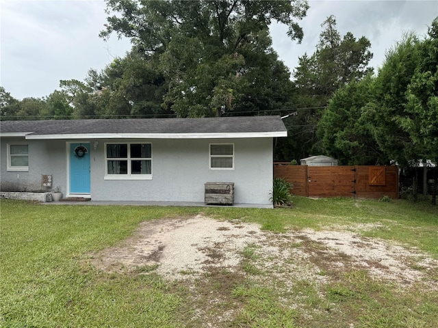 rear view of property featuring a yard