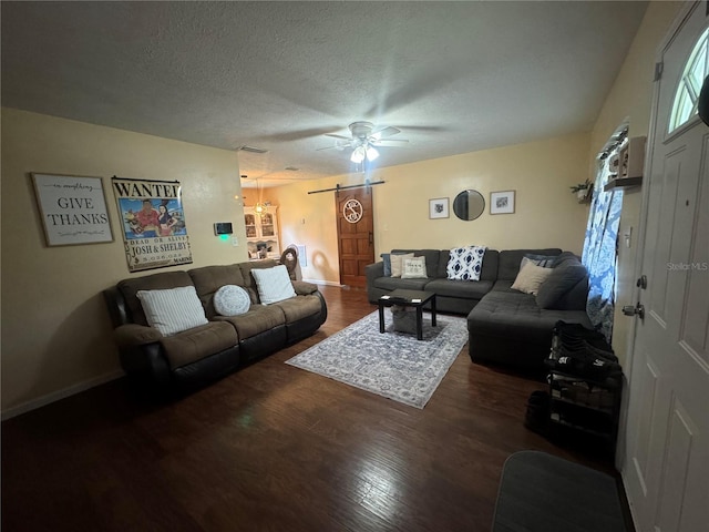 living room featuring dark hardwood / wood-style flooring, a textured ceiling, and ceiling fan