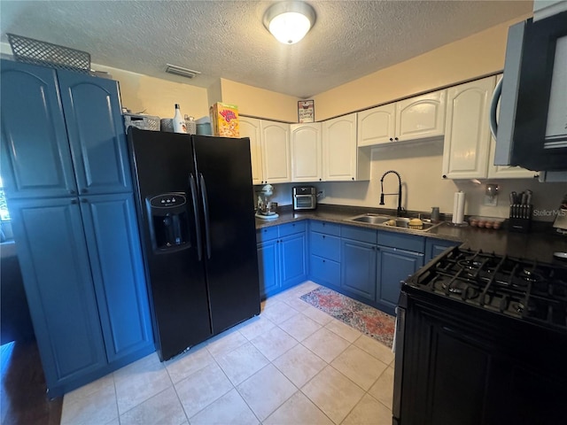 kitchen featuring white cabinetry, sink, black appliances, light tile patterned flooring, and blue cabinets