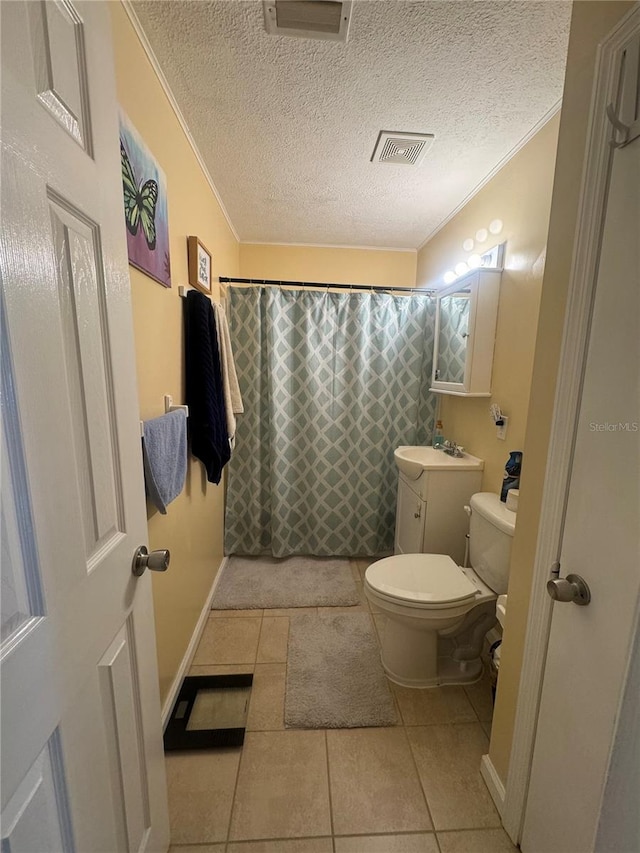 bathroom with a textured ceiling, tile patterned flooring, vanity, crown molding, and toilet