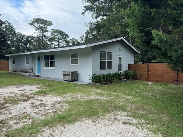 rear view of property with a lawn