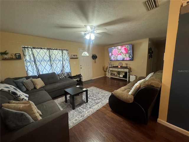 living room featuring hardwood / wood-style floors, ceiling fan, and a textured ceiling