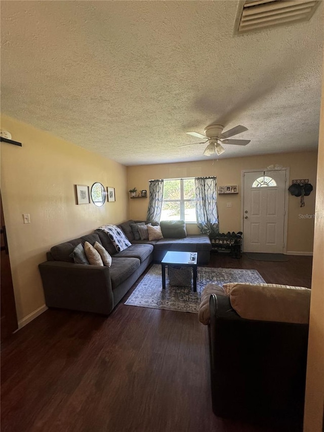 living room featuring ceiling fan, a textured ceiling, and hardwood / wood-style floors