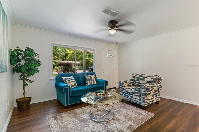 living room with ceiling fan, crown molding, and dark hardwood / wood-style floors