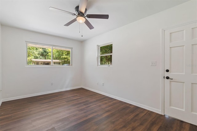 spare room featuring ceiling fan and dark wood-type flooring