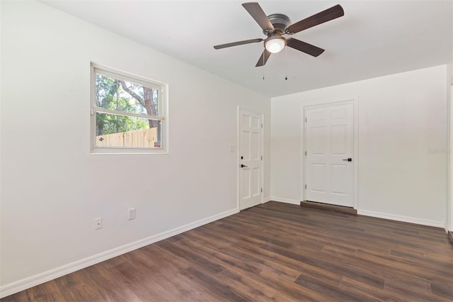 unfurnished room with ceiling fan and dark hardwood / wood-style floors